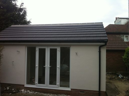 A modern garden building with a sloped roof and double doors.